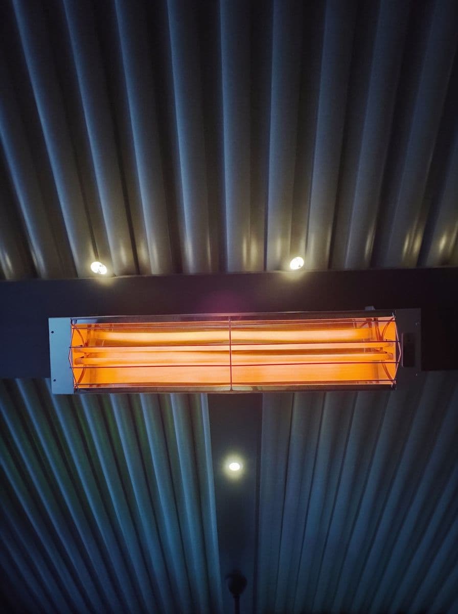 A Bromic heater mounted to the roof of a covered patio to provide warmth during Colorado's colder months.